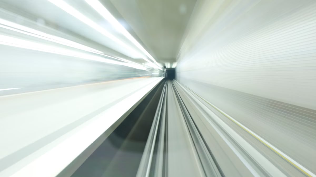 Abstract motion blur inside a modern, illuminated subway tunnel in Nuremberg, Germany. Long exposure shot.